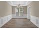 Dining area with hardwood floors, neutral paint, and decorative chair rail trim at 3401 Ravensworth Trce, Kennesaw, GA 30144