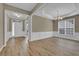 Light-filled dining room with elegant white wainscoting and hardwood floors at 3401 Ravensworth Trce, Kennesaw, GA 30144
