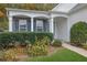 Charming home entrance with stone accents, blue shutters, and well-maintained landscaping at 3401 Ravensworth Trce, Kennesaw, GA 30144