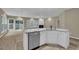 Open kitchen featuring a stainless steel dishwasher and sink, with a granite countertop island at 3401 Ravensworth Trce, Kennesaw, GA 30144