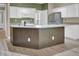 Kitchen island with granite countertops and seating; stainless steel refrigerator included at 3401 Ravensworth Trce, Kennesaw, GA 30144