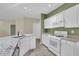 Bright kitchen with white cabinets, granite counters, and modern appliances at 3401 Ravensworth Trce, Kennesaw, GA 30144