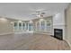 Bright living room featuring a fireplace, recessed lighting, and large windows with backyard views at 3401 Ravensworth Trce, Kennesaw, GA 30144
