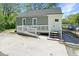 Charming home exterior featuring gray siding and a front ramp at 5024 Park Ave, Forest Park, GA 30297