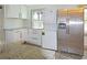 Kitchen features stainless refrigerator, modern appliances and laundry hookups at 5024 Park Ave, Forest Park, GA 30297