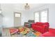 The living room features bright natural light, with updated ceiling fan and refinished floors at 5024 Park Ave, Forest Park, GA 30297