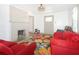 A spacious living room has a fireplace, bright window, comfortable sofa, and a colorful rug at 5024 Park Ave, Forest Park, GA 30297