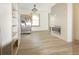 Open-concept living room featuring modern fireplace, stainless refrigerator and wood-look flooring at 5024 Park Ave, Forest Park, GA 30297