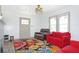 The living room features bright natural light, with updated ceiling fan and refinished floors at 5024 Park Ave, Forest Park, GA 30297