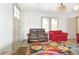 A comfortable living room is accented by a colorful rug and neutral walls at 5024 Park Ave, Forest Park, GA 30297