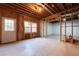 Unfinished basement space with potential, featuring exposed framing, a window, and a door at 5405 Preserve Cir, Johns Creek, GA 30005