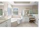 Well-lit bathroom with a soaking tub, granite countertops, dual sinks, and lots of counter space at 5405 Preserve Cir, Johns Creek, GA 30005