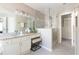 Well-lit bathroom featuring granite countertops, vanity with stool, glass shower, and walk-in closet at 5405 Preserve Cir, Johns Creek, GA 30005