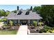 Beautiful clubhouse exterior featuring a manicured lawn and inviting entrance at 5405 Preserve Cir, Johns Creek, GA 30005