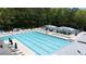 Large community pool with marked swim lanes and seating surrounded by shade umbrellas at 5405 Preserve Cir, Johns Creek, GA 30005