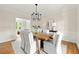 Elegant dining room with stylish lighting, a wooden table, six upholstered chairs and hardwood flooring at 5405 Preserve Cir, Johns Creek, GA 30005
