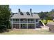 Beautiful home exterior featuring a stone base, balconies, and well-maintained lawn at 5405 Preserve Cir, Johns Creek, GA 30005