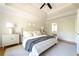 Bright main bedroom suite with vaulted ceilings, fan, and neutral decor. Bathroom suite access at 5405 Preserve Cir, Johns Creek, GA 30005