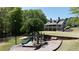 Community playground featuring slides and climbing bars situated near residential homes at 5405 Preserve Cir, Johns Creek, GA 30005
