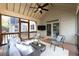 Cozy screened porch with ceiling fan and plush seating at 5405 Preserve Cir, Johns Creek, GA 30005