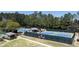 Outdoor tennis courts with viewing area for spectators surrounded by mature trees at 5405 Preserve Cir, Johns Creek, GA 30005