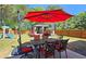 Outdoor patio with an umbrella, dining set, and a play set in the backyard at 542 Simonton Ridge Trl, Lawrenceville, GA 30045