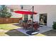 Backyard patio with dining set, umbrella, and well-manicured lawn at 542 Simonton Ridge Trl, Lawrenceville, GA 30045