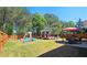 Spacious backyard with a gazebo, playground, lawn, and trees at 542 Simonton Ridge Trl, Lawrenceville, GA 30045