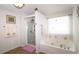 Relaxing bathroom featuring a shower, and a separate soaking tub by a window at 542 Simonton Ridge Trl, Lawrenceville, GA 30045