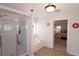 Bright bathroom with a shower and a separate soaking tub by a doorway leading to bedroom at 542 Simonton Ridge Trl, Lawrenceville, GA 30045