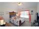 Cozy bedroom with a ceiling fan, and decorated window with bright lighting at 542 Simonton Ridge Trl, Lawrenceville, GA 30045