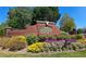 Landscaped community entrance sign with vibrant flowers and greenery at Ridgeview at 542 Simonton Ridge Trl, Lawrenceville, GA 30045