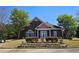 Charming brick building with manicured landscaping, colorful flowers, and lush trees at 542 Simonton Ridge Trl, Lawrenceville, GA 30045