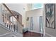 Bright foyer with hardwood floors, soaring ceilings, and staircase with white banisters at 542 Simonton Ridge Trl, Lawrenceville, GA 30045