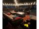 Cozy gazebo featuring plush seating, a fire pit, and ambient lighting for evening relaxation at 542 Simonton Ridge Trl, Lawrenceville, GA 30045