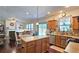 Bright kitchen with center island, wood cabinets, stainless dishwasher, and backyard view at 542 Simonton Ridge Trl, Lawrenceville, GA 30045