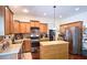Well-equipped kitchen with stainless steel appliances, center island, and custom cabinetry at 542 Simonton Ridge Trl, Lawrenceville, GA 30045