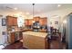 Well-lit kitchen featuring an island, stainless steel appliances, and beautiful wood floors at 542 Simonton Ridge Trl, Lawrenceville, GA 30045