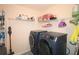 Convenient laundry room featuring washer and dryer hookups and shelving at 542 Simonton Ridge Trl, Lawrenceville, GA 30045