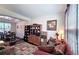 Cozy living room with comfortable seating, hardwood floors, and view into the dining area at 542 Simonton Ridge Trl, Lawrenceville, GA 30045