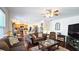 Open living space featuring hardwood floors, kitchen, and comfortable seating at 542 Simonton Ridge Trl, Lawrenceville, GA 30045