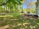 Spacious backyard and outdoor seating area with grill, fire pit, and mature trees at 1835 Penrose Ct, Powder Springs, GA 30127