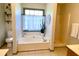 Bright bathroom featuring a garden tub, separate shower, and tiled floors at 1835 Penrose Ct, Powder Springs, GA 30127