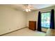 Neat bedroom with natural light from the window and a wooden dresser at 1835 Penrose Ct, Powder Springs, GA 30127