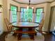 Bay window dining area with rustic wood table and natural lighting at 1835 Penrose Ct, Powder Springs, GA 30127