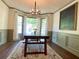 Dining room featuring a large table, bay windows and custom trim at 1835 Penrose Ct, Powder Springs, GA 30127