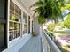 Charming front porch with decorative fern and colorful potted flowers along the railing at 1835 Penrose Ct, Powder Springs, GA 30127