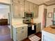 Kitchen with stainless steel appliances and adjoining access to living room at 1835 Penrose Ct, Powder Springs, GA 30127