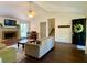 Comfortable living room with a brick fireplace, piano, and dark wood floors at 1835 Penrose Ct, Powder Springs, GA 30127