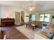 Spacious living room with hardwood floors, a ceiling fan, and large windows offering natural light at 1835 Penrose Ct, Powder Springs, GA 30127
